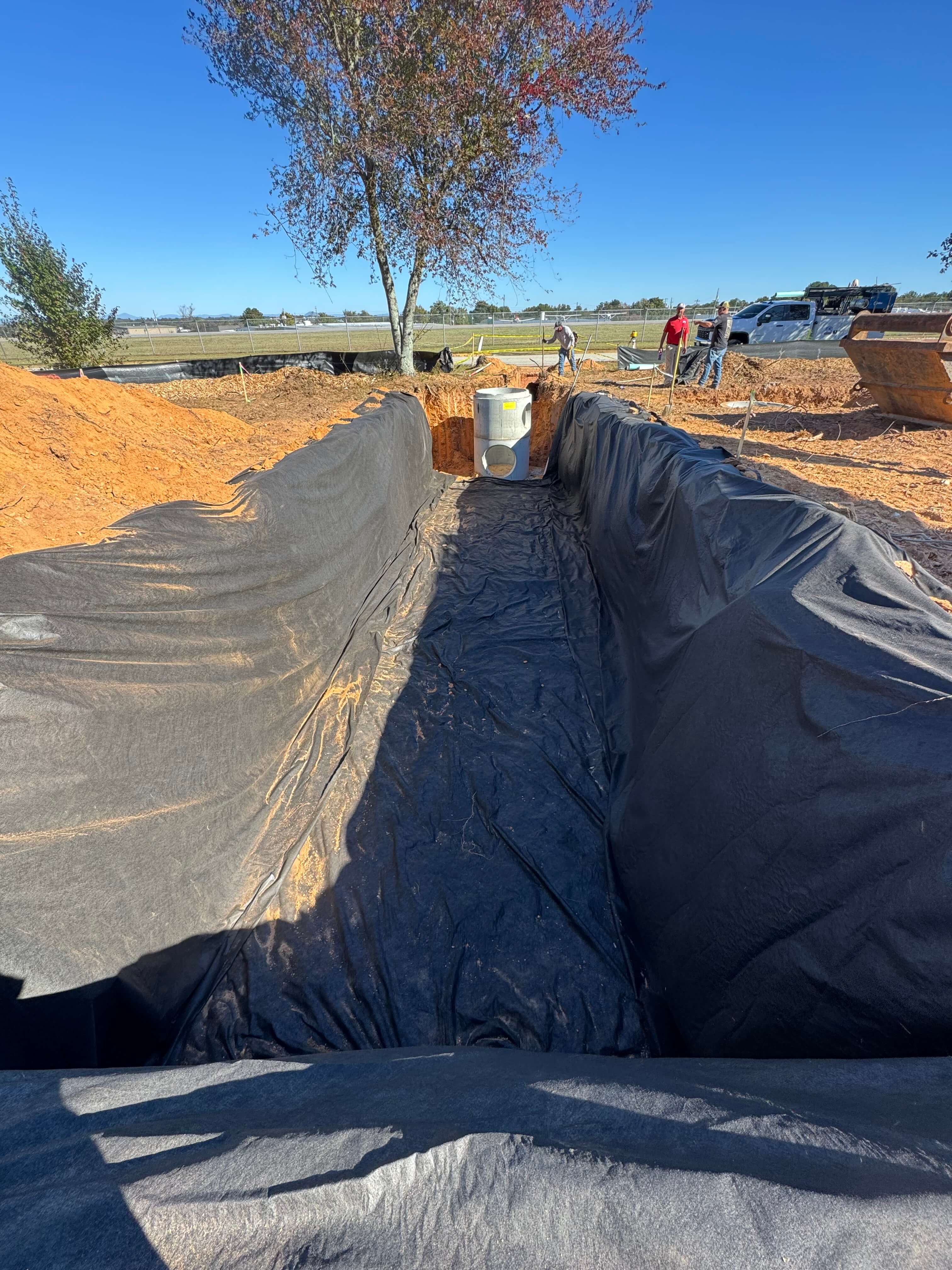 Storm pond drain field construction for stormwater management in Cumming, Forsyth County, Georgia